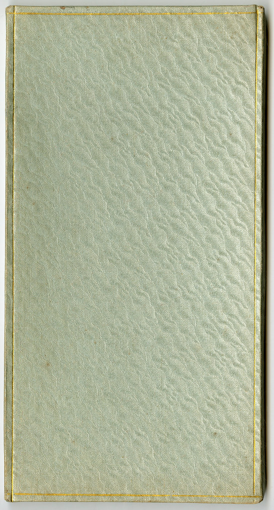 A closed book with a textured cover in light blue and gold accents.