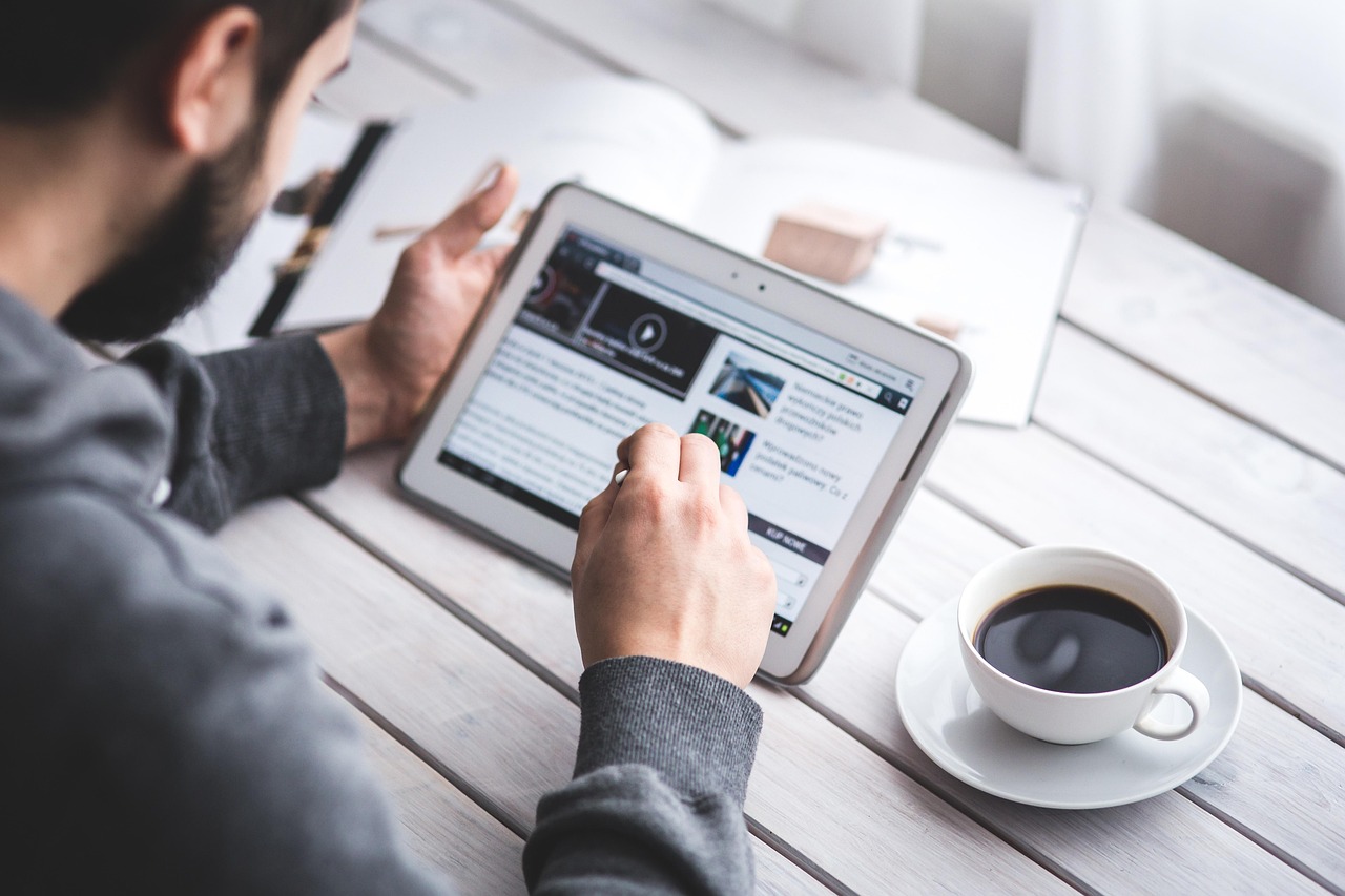 Man, reading, touchscreen — How to Use the Nifty Option Chain to Protect Your Capital?
