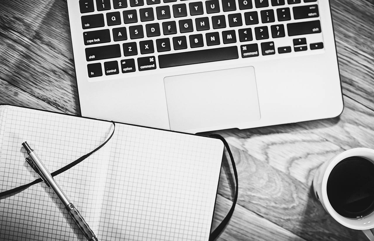 Computer, notebook, coffee — Luton Van Hire Near Me: How to Find Affordable Rentals