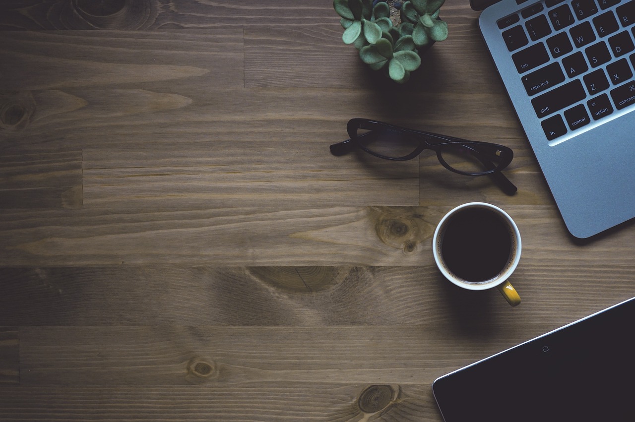 Workspace, coffee, laptop — Revolutionizing Customer Experience: How Modern AI IVR Solutions Are Transforming Call Centers fo