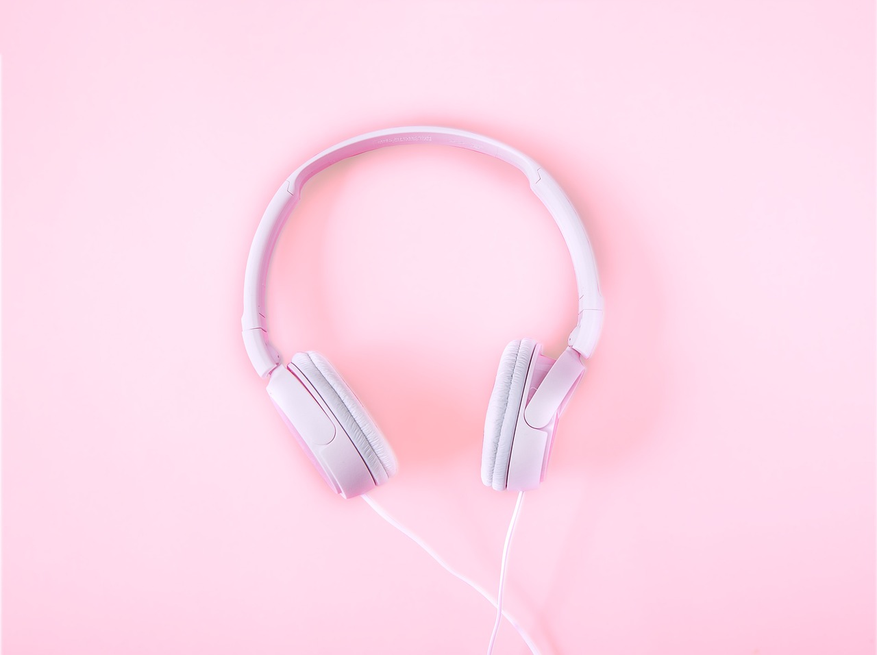 Headsets, music, pink background — Unlocking Business Potential: The Power of Paid Advertising